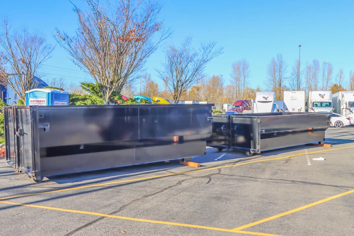 Professional dumpster rental service with roll-off container on residential driveway in Covington